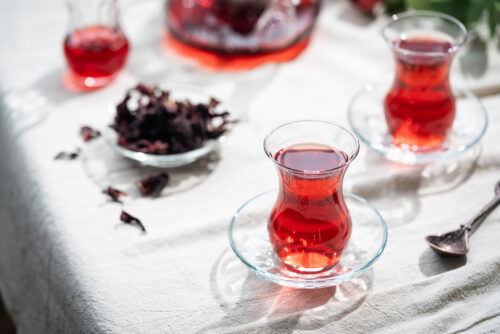 Hot red karkade tea in a glasses on rustic background